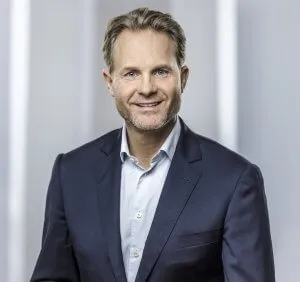 Mann mit  trägt einen Anzug und lächelt